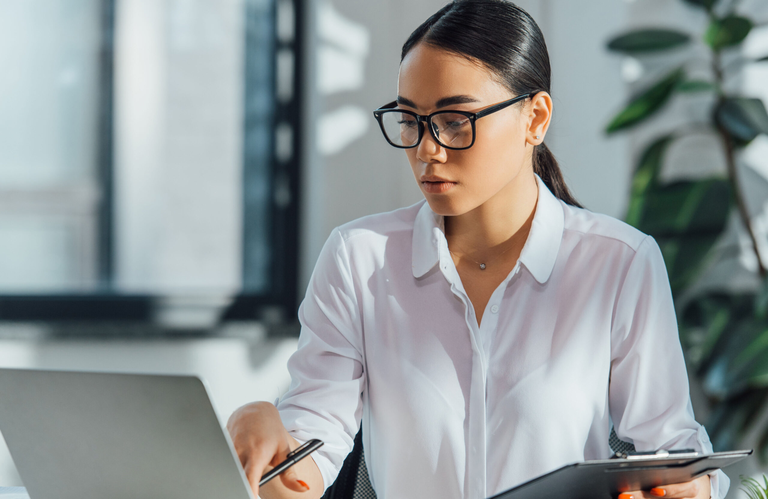 Wooden gavel on table in courtroom. People blurred in background. Legal justice, law concept. Focus on instrument. Child custody, divorce, family law. Conflict resolution, legal counsel dispute